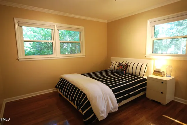 a bedroom with a bed and a lamp