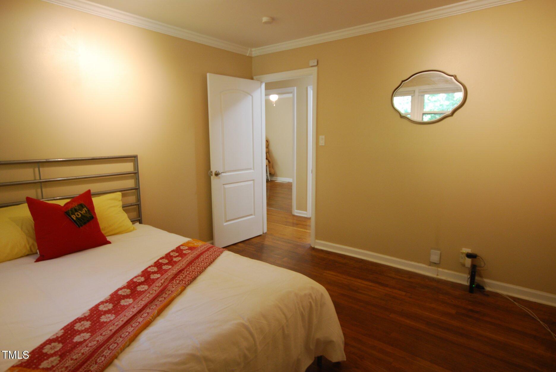 416 Morreene Road Durham, NC 27705 - Photo 15 of 28 a bedroom with a bed and a lamp