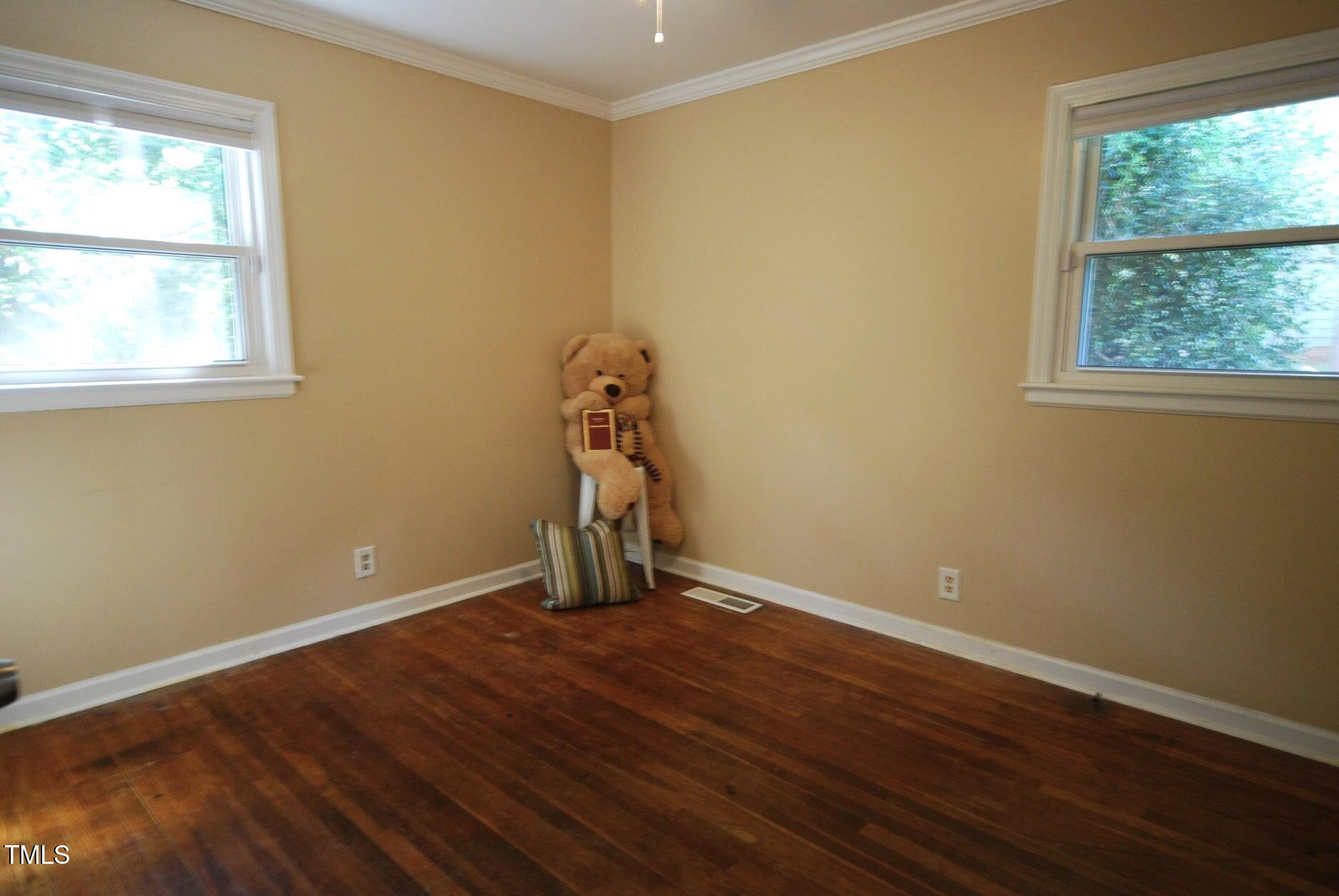 416 Morreene Road Durham, NC 27705 - Photo 17 of 28 a view of an empty room with wooden floor and a window