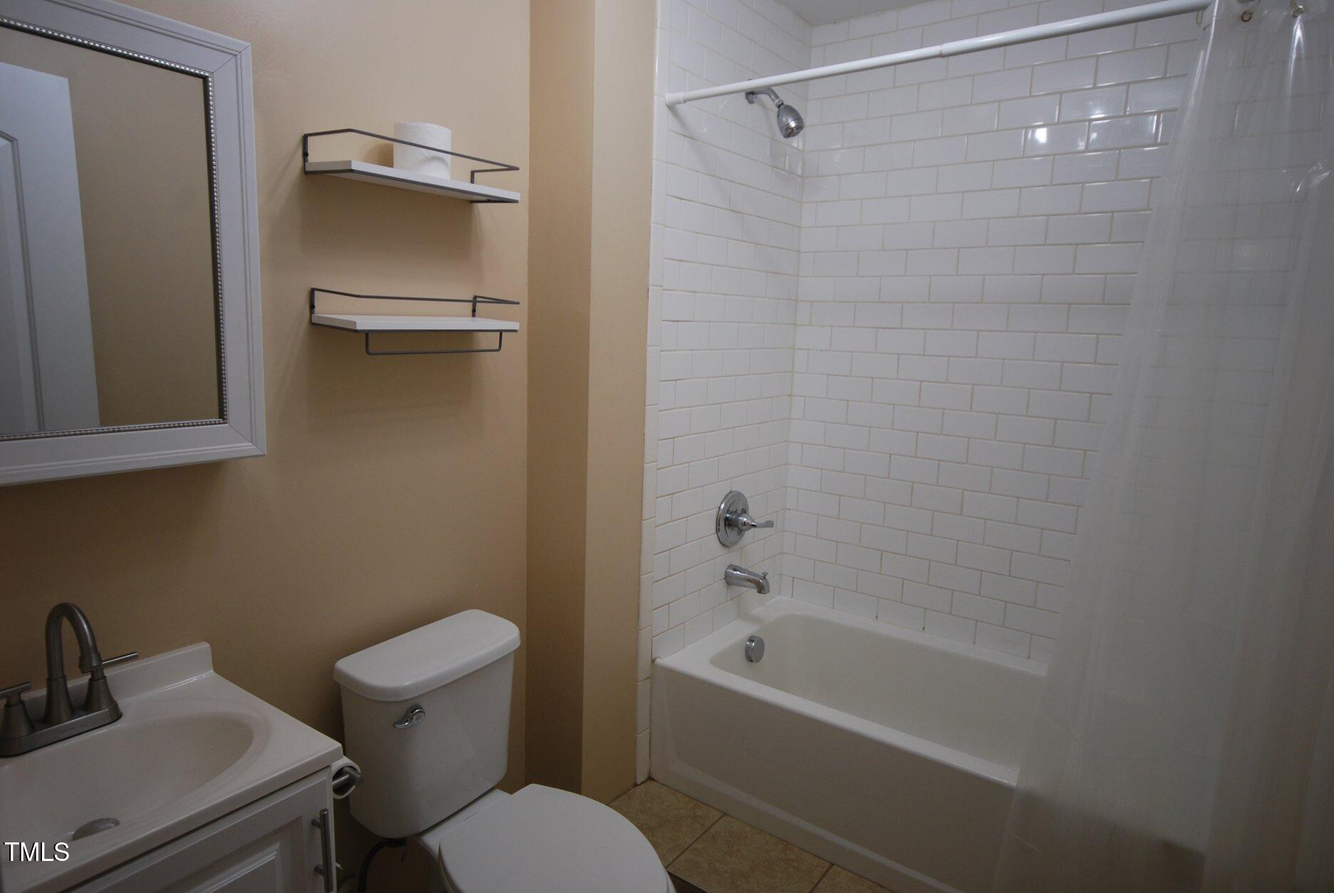 416 Morreene Road Durham, NC 27705 - Photo 19 of 28 a bathroom with a sink toilet and bathtub