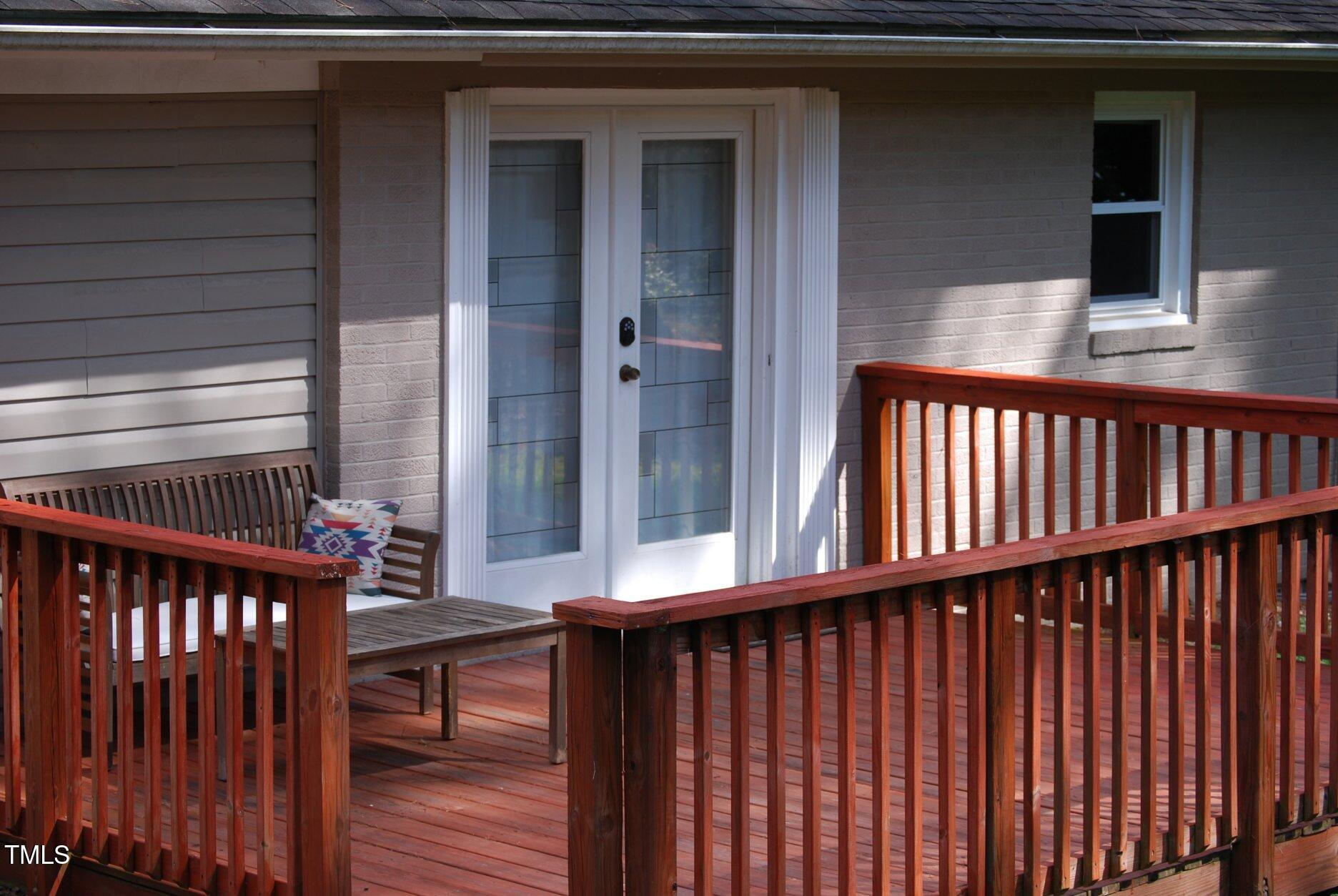 416 Morreene Road Durham, NC 27705 - Photo 3 of 28 a view of a balcony with furniture and wooden floor
