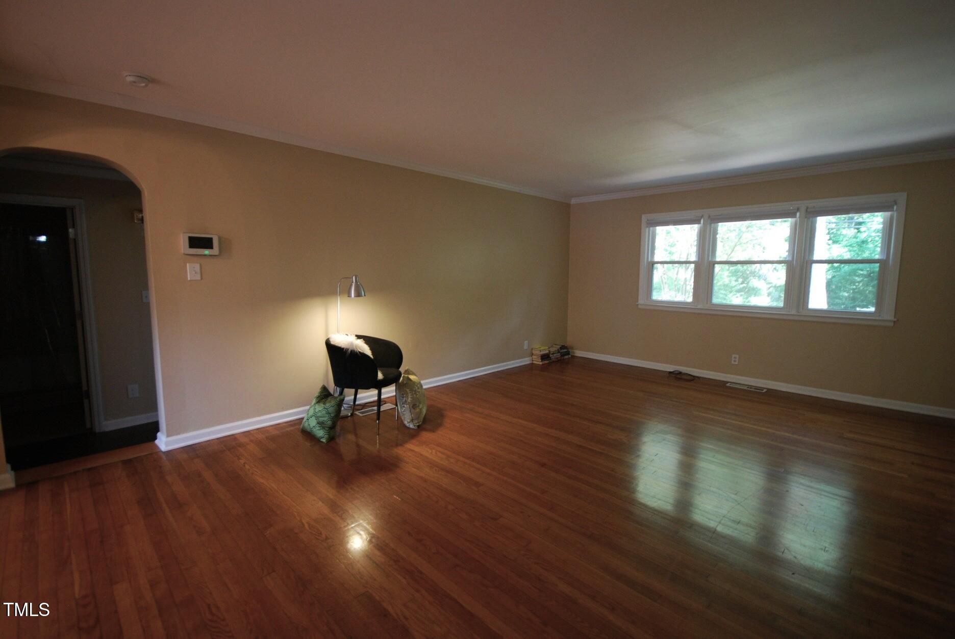 416 Morreene Road Durham, NC 27705 - Photo 5 of 28 a living room with wooden floor and a table