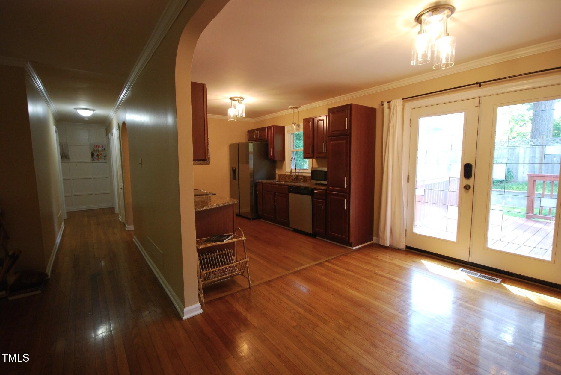 416 Morreene Road Durham, NC 27705 - Photo 8 of 28 a view of a kitchen with wooden floor and a refrigerator