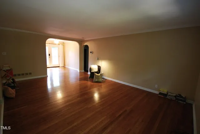 a view of a room with gym equipment and wooden floor