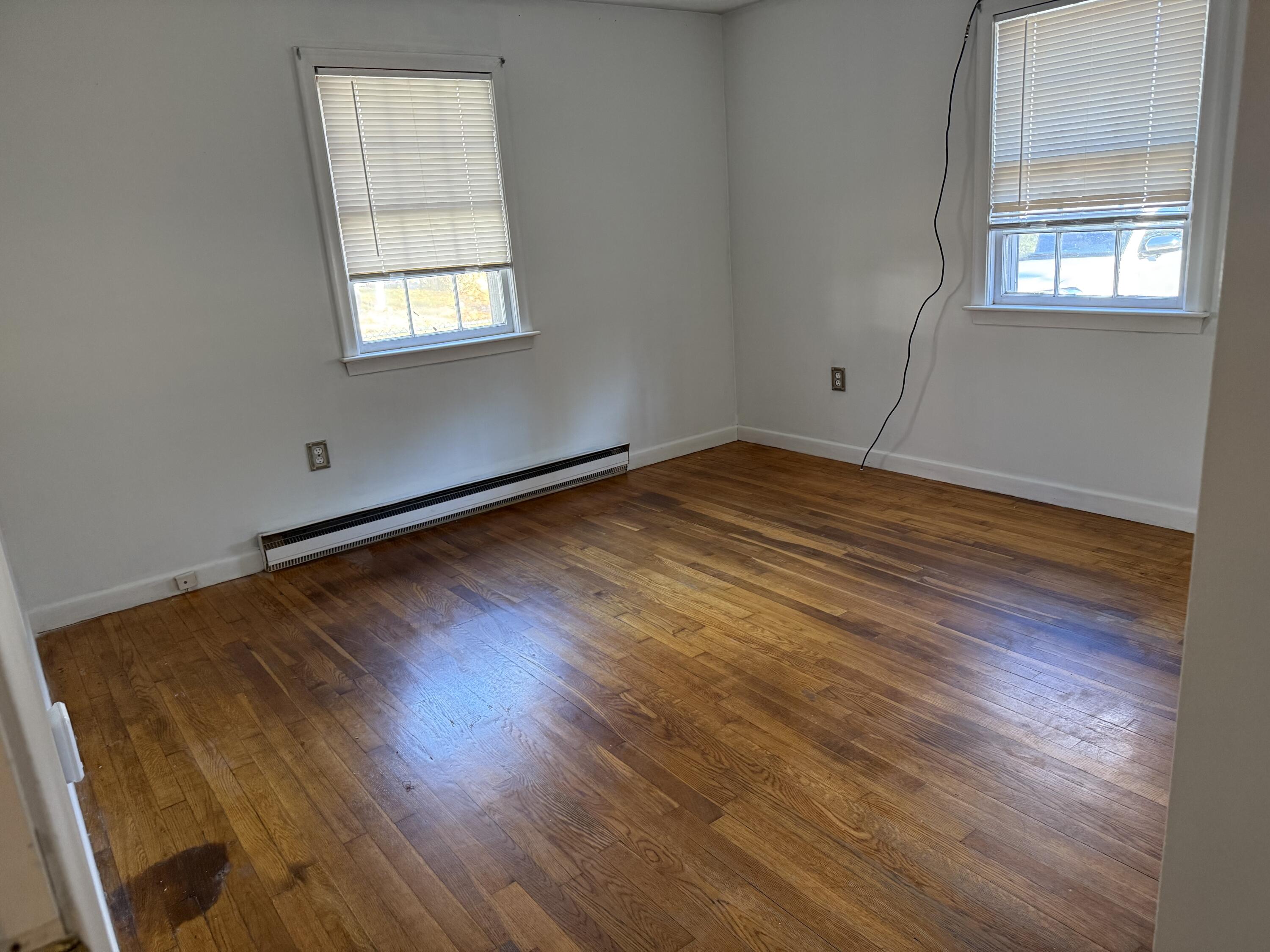 5 Huckleberry Lane Marstons Mills, MA 02648 - Photo 11 of 14 an empty room with wooden floor and windows