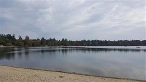 5 Huckleberry Lane Marstons Mills, MA 02648 - Photo 12 of 14 a view of a lake with houses in the back