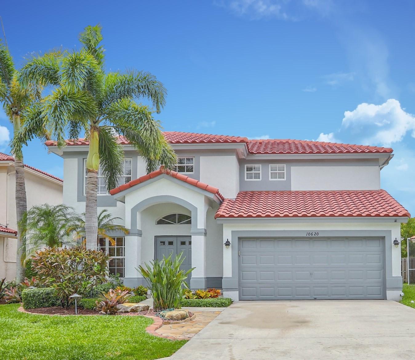 10620 Lake Jasmine Drive Boca Raton, FL 33498 - Photo 1 of 41 a front view of a house with garden