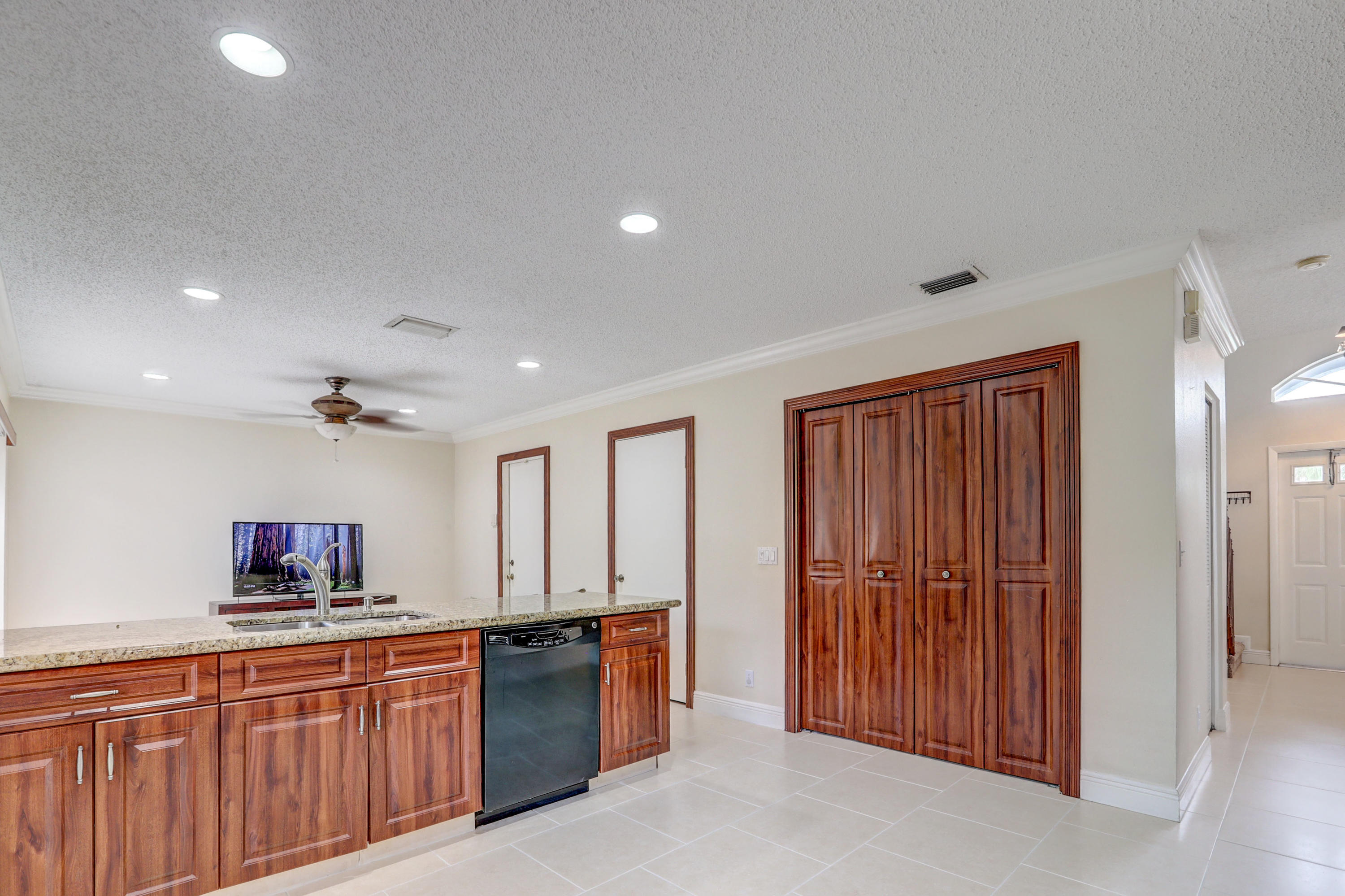 10620 Lake Jasmine Drive Boca Raton, FL 33498 - Photo 12 of 41 a view of kitchen with sink wooden cabinets and refrigerator