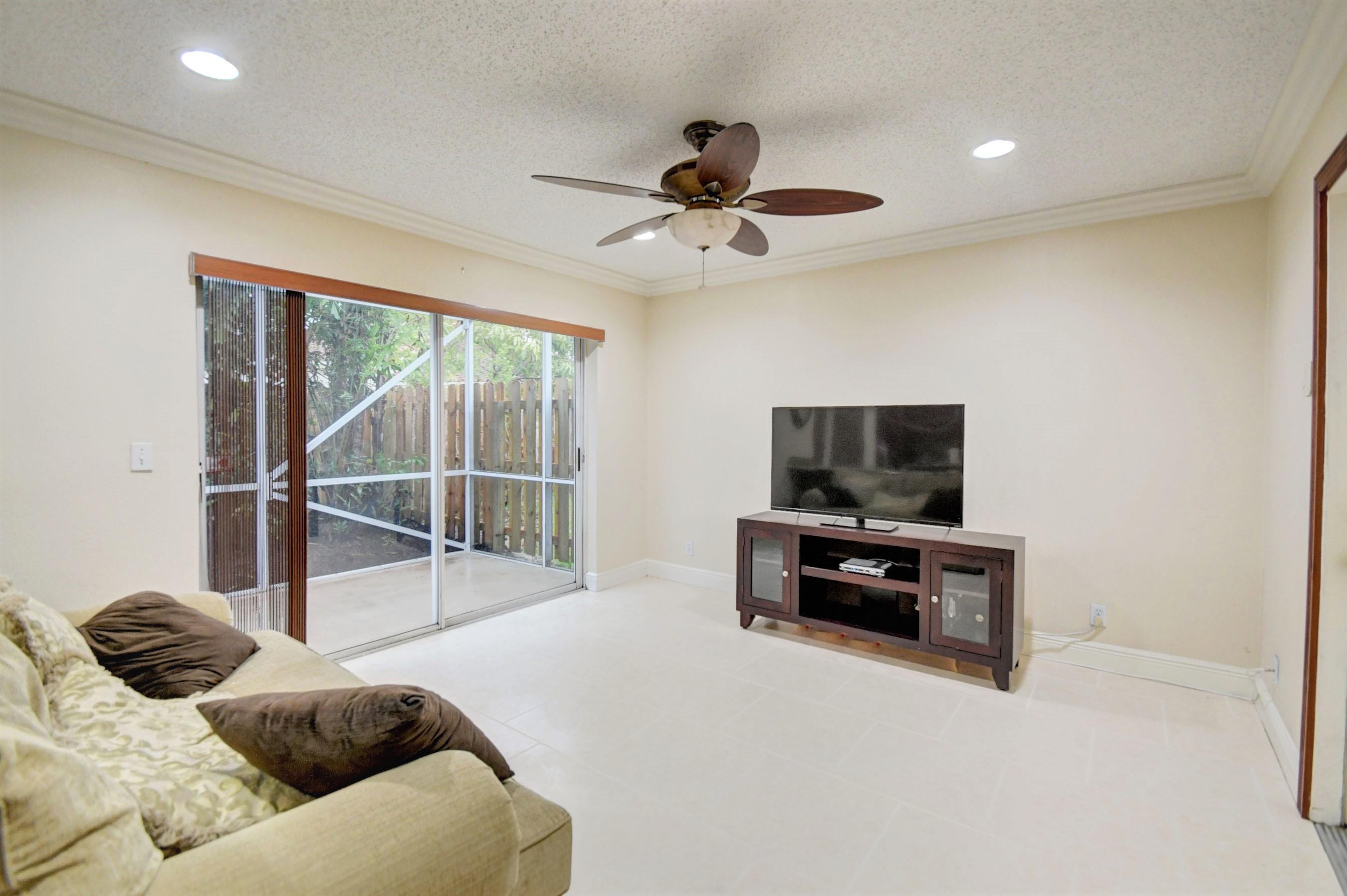 10620 Lake Jasmine Drive Boca Raton, FL 33498 - Photo 13 of 41 a bedroom with a bed and a flat screen tv
