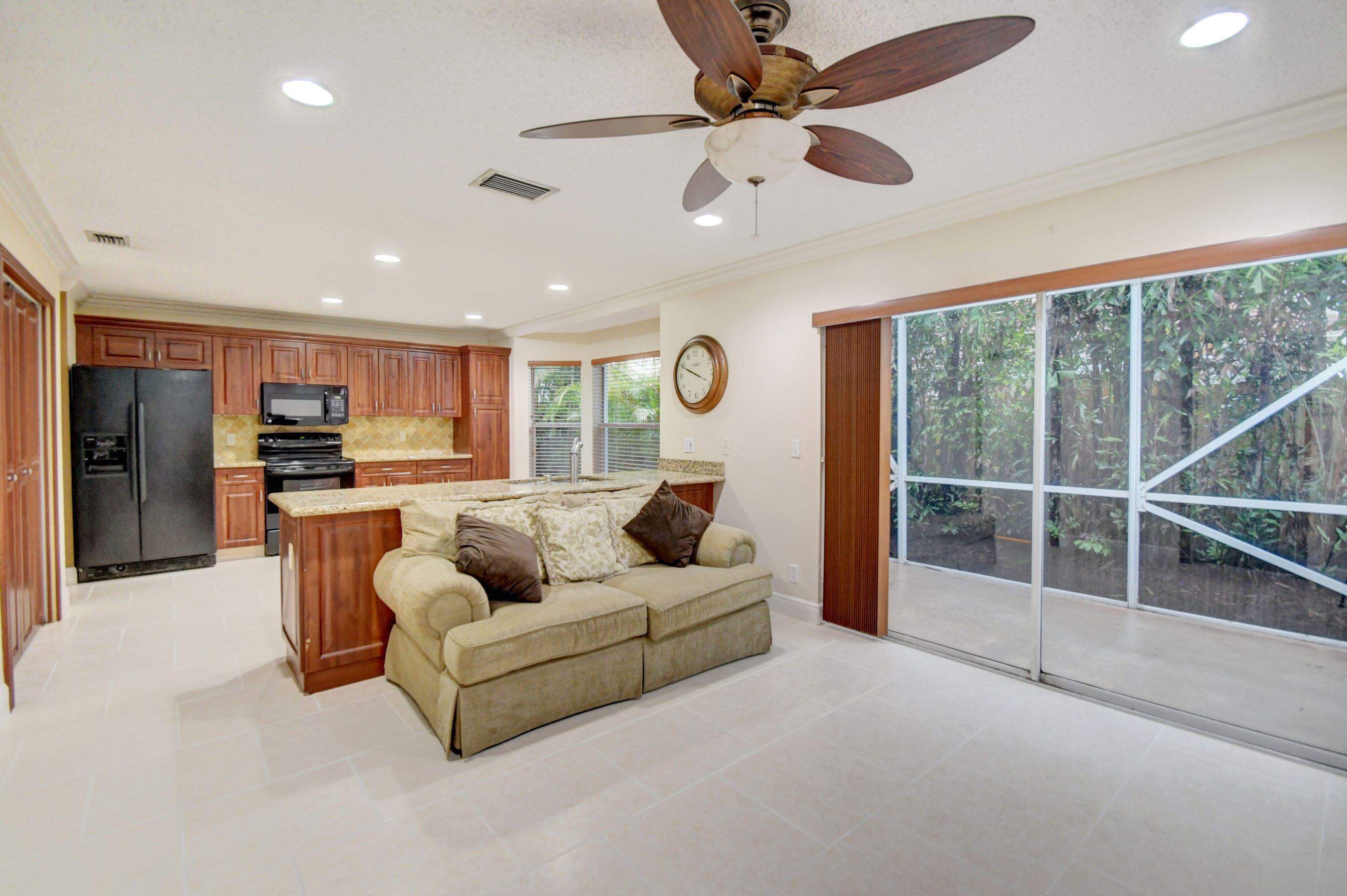 10620 Lake Jasmine Drive Boca Raton, FL 33498 - Photo 15 of 41 a living room with furniture and a large window with kitchen view