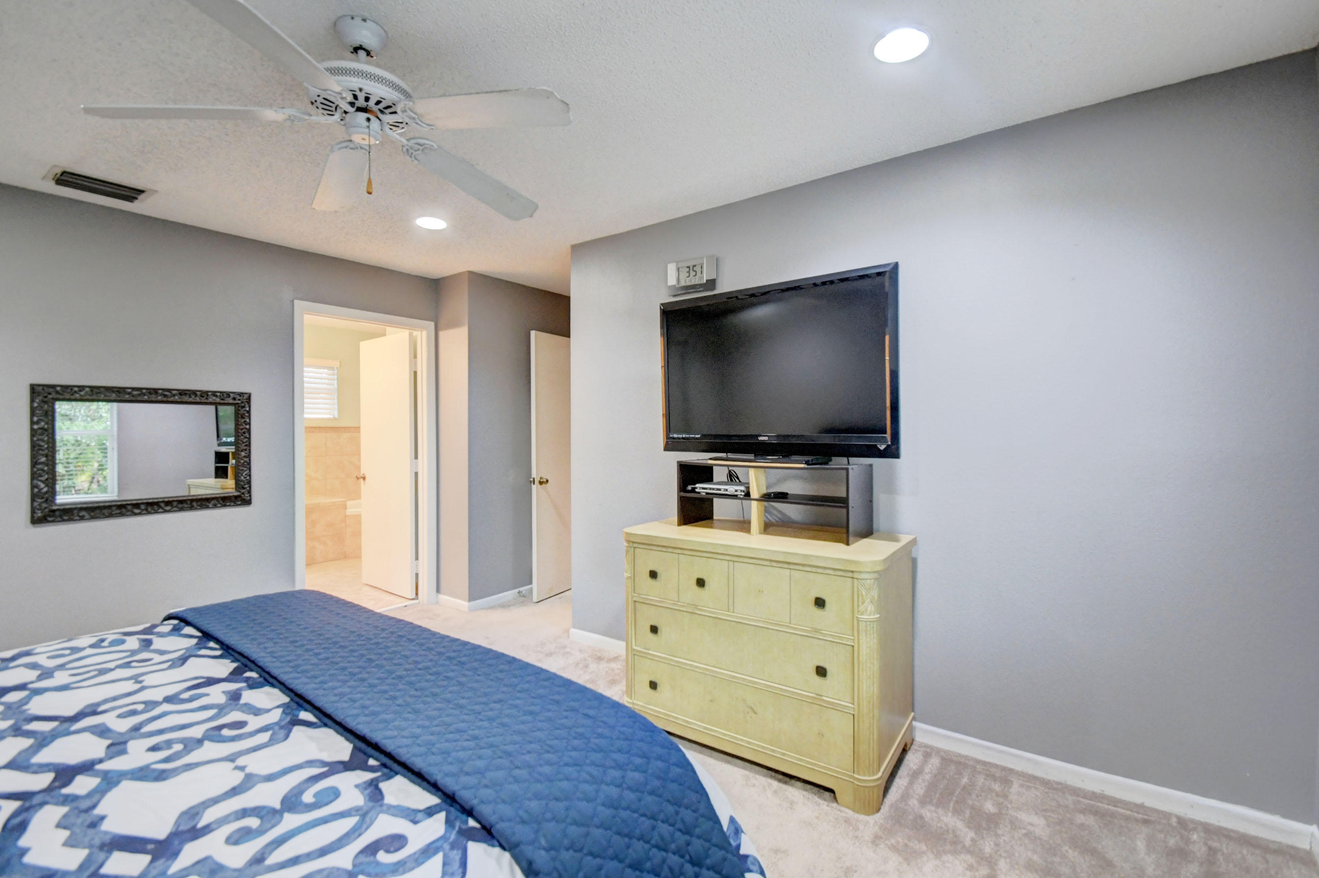 10620 Lake Jasmine Drive Boca Raton, FL 33498 - Photo 19 of 41 a bedroom with a bed and a flat screen tv
