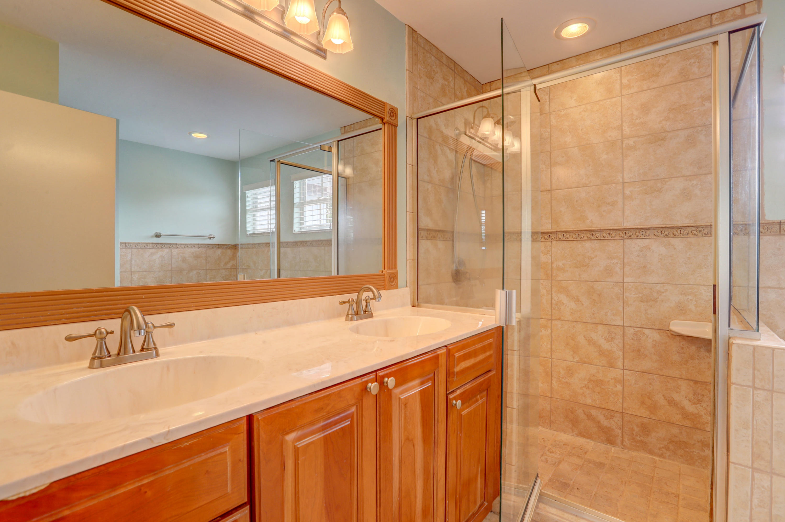 10620 Lake Jasmine Drive Boca Raton, FL 33498 - Photo 20 of 41 a bathroom with a sink and a shower