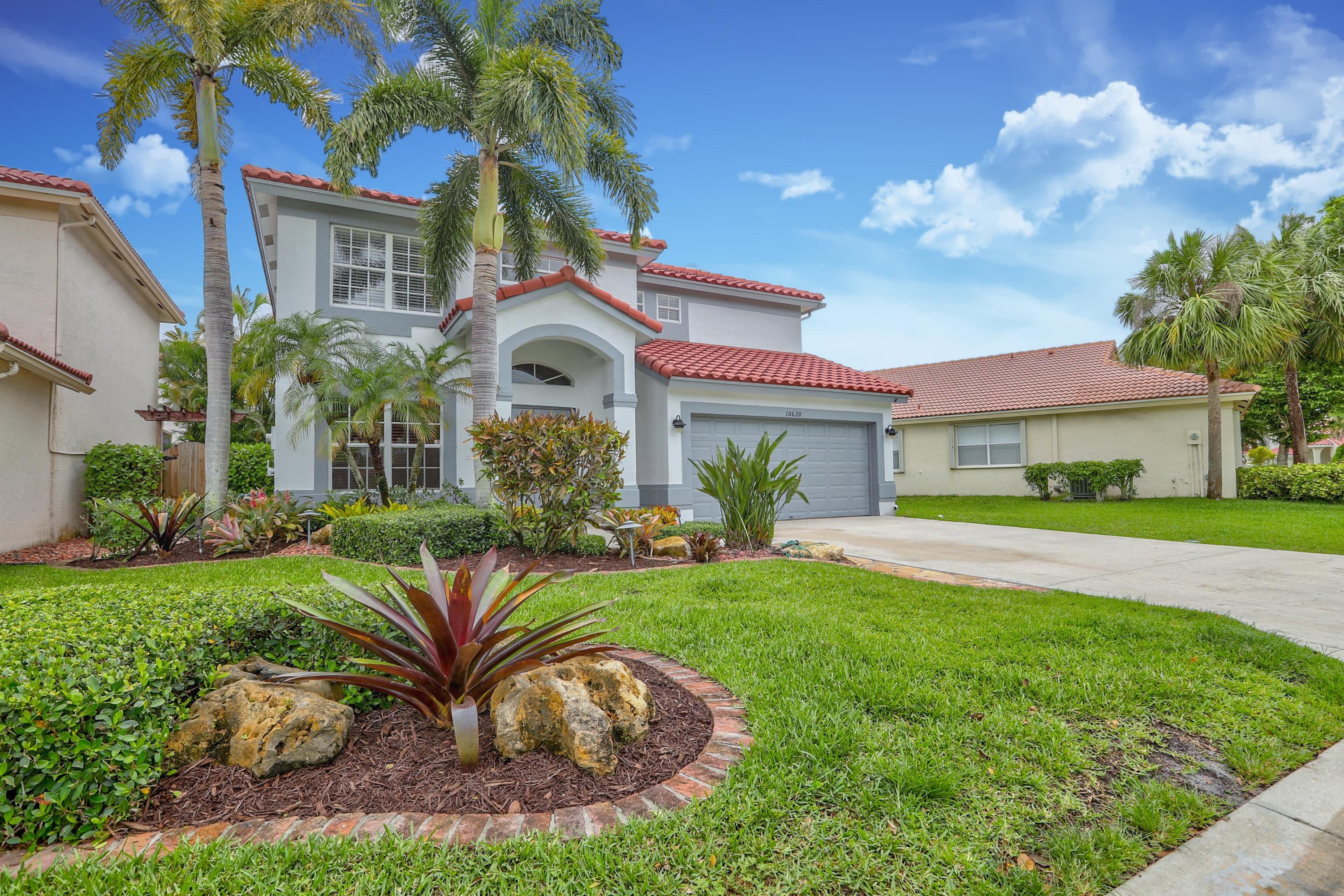 10620 Lake Jasmine Drive Boca Raton, FL 33498 - Photo 2 of 41 a view of a house with a big yard plants and large trees