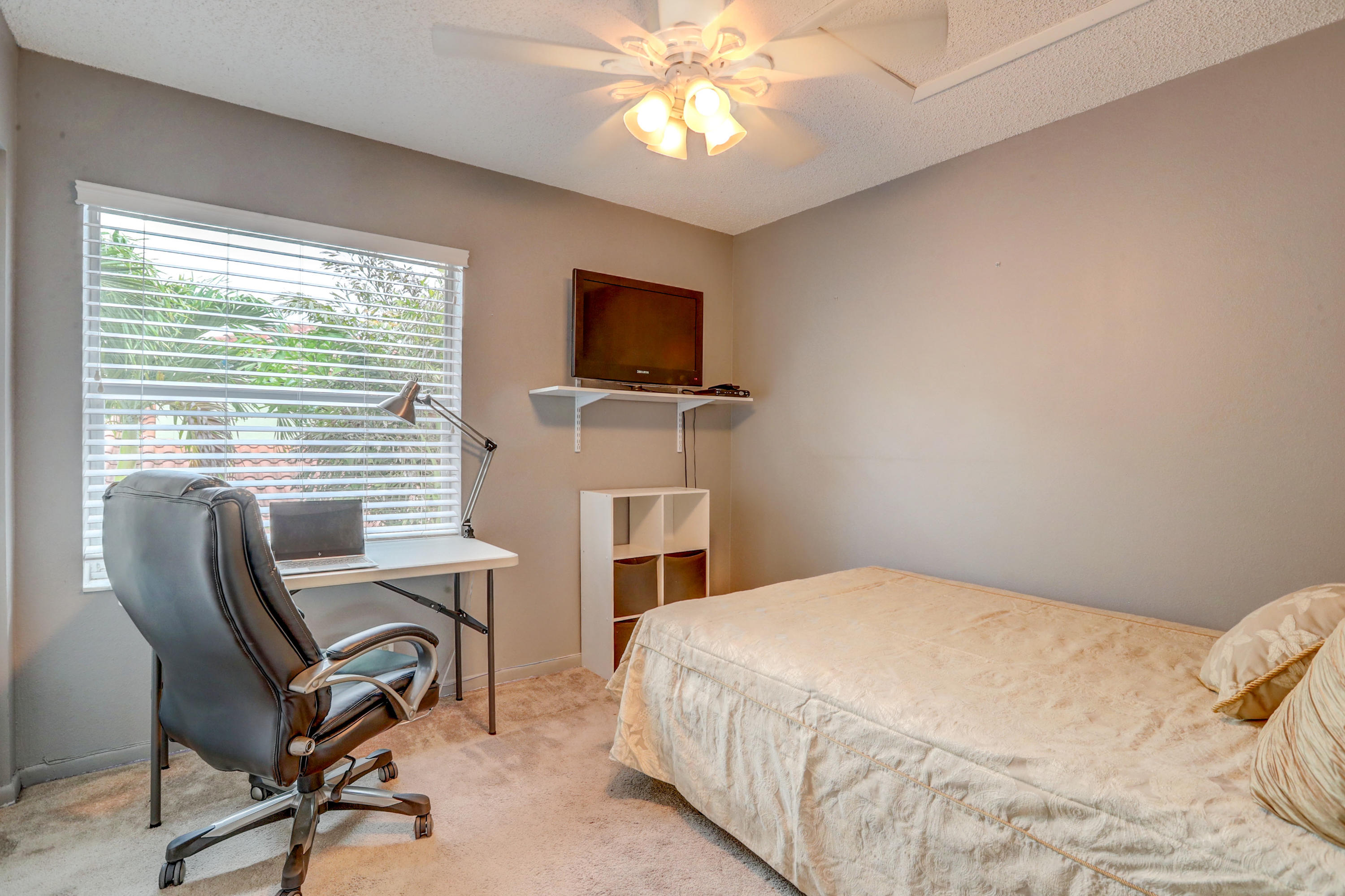10620 Lake Jasmine Drive Boca Raton, FL 33498 - Photo 22 of 41 a bedroom with a bed and a flat screen tv