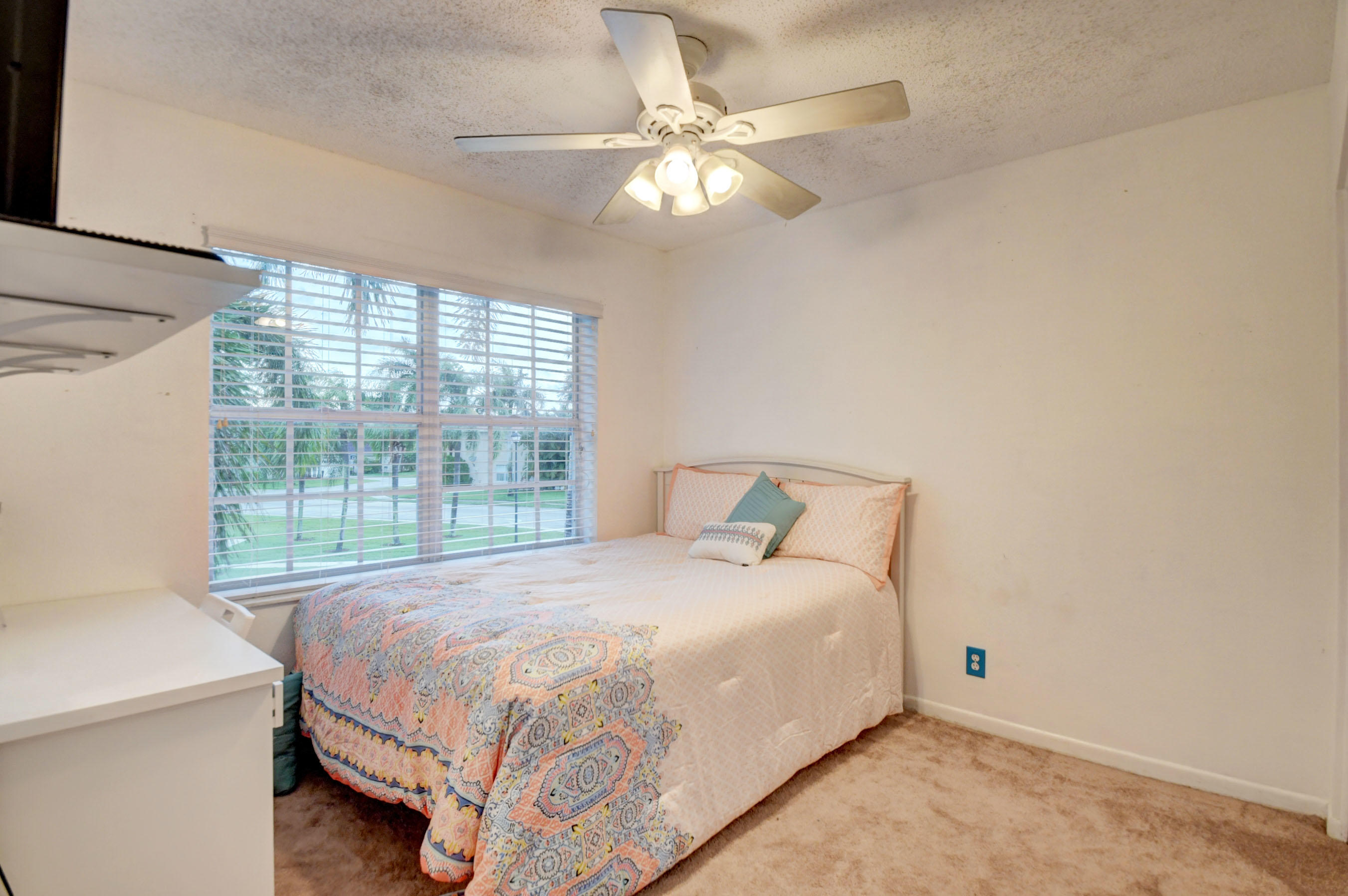 10620 Lake Jasmine Drive Boca Raton, FL 33498 - Photo 23 of 41 a bedroom with a bed and a chandelier