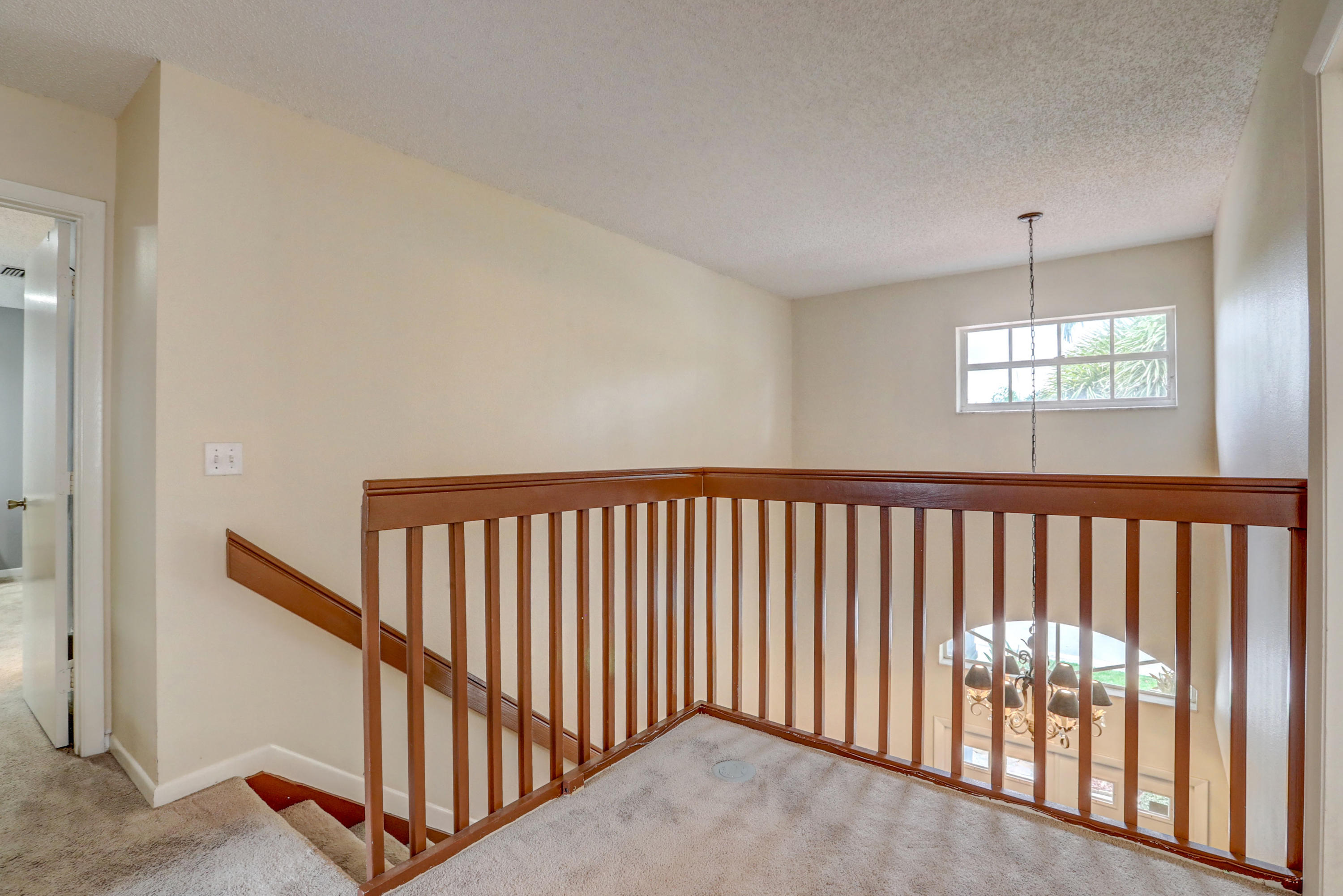 10620 Lake Jasmine Drive Boca Raton, FL 33498 - Photo 25 of 41 a view of staircase with railing and a window