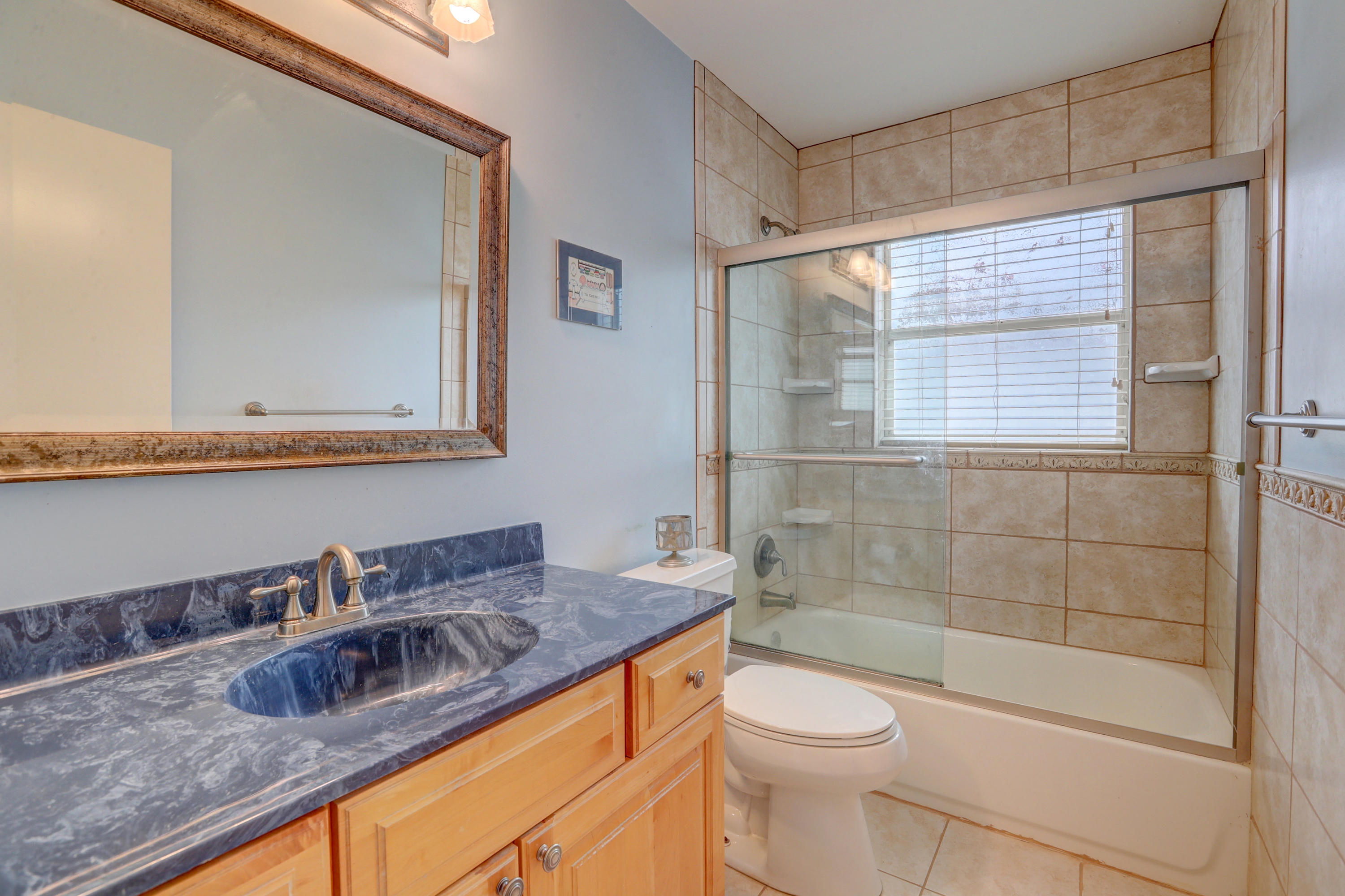 10620 Lake Jasmine Drive Boca Raton, FL 33498 - Photo 27 of 41 a bathroom with a granite countertop sink toilet and shower