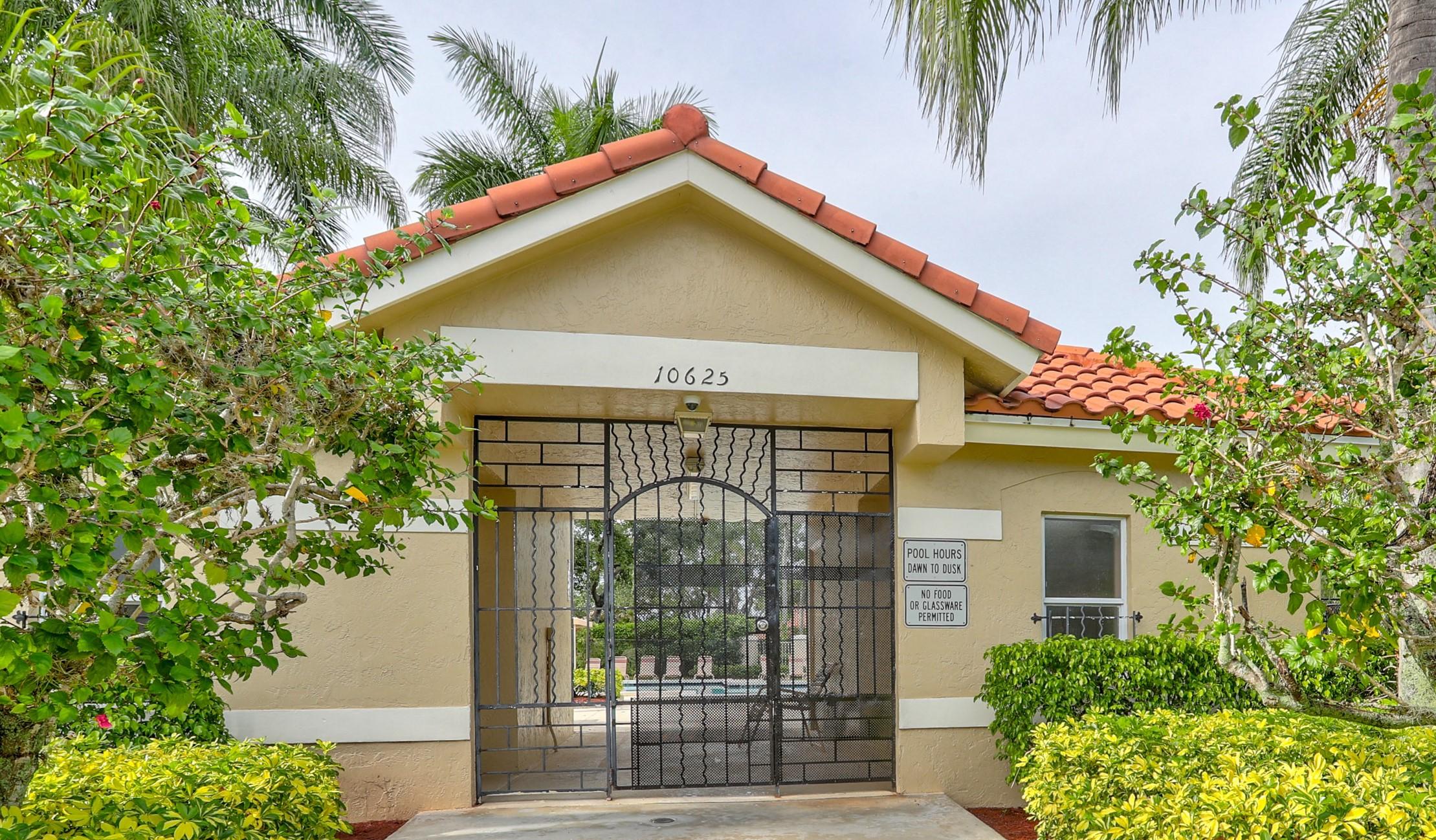 10620 Lake Jasmine Drive Boca Raton, FL 33498 - Photo 35 of 41 a front view of a house with a garden