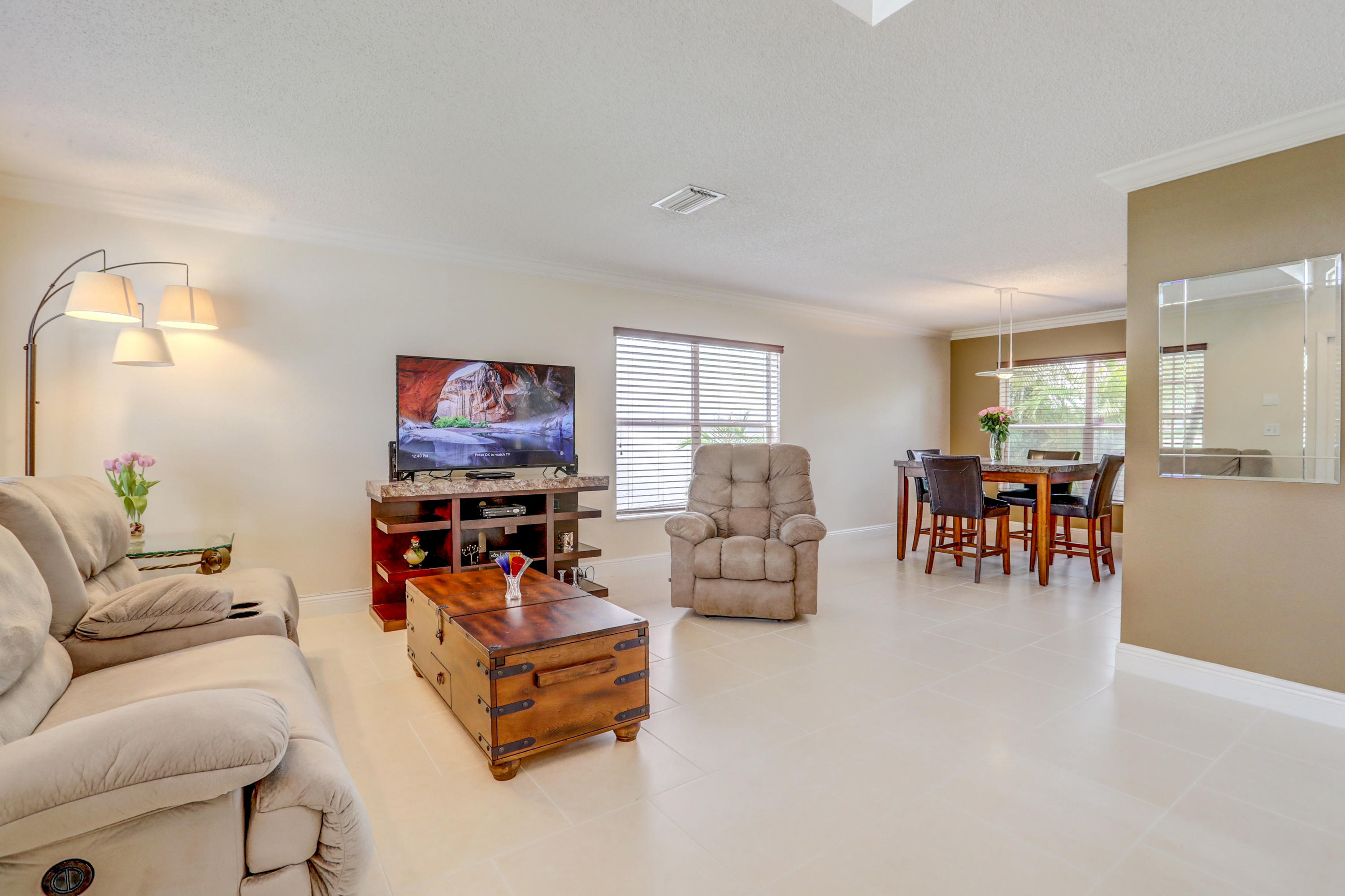 10620 Lake Jasmine Drive Boca Raton, FL 33498 - Photo 4 of 41 a living room with furniture and a flat screen tv