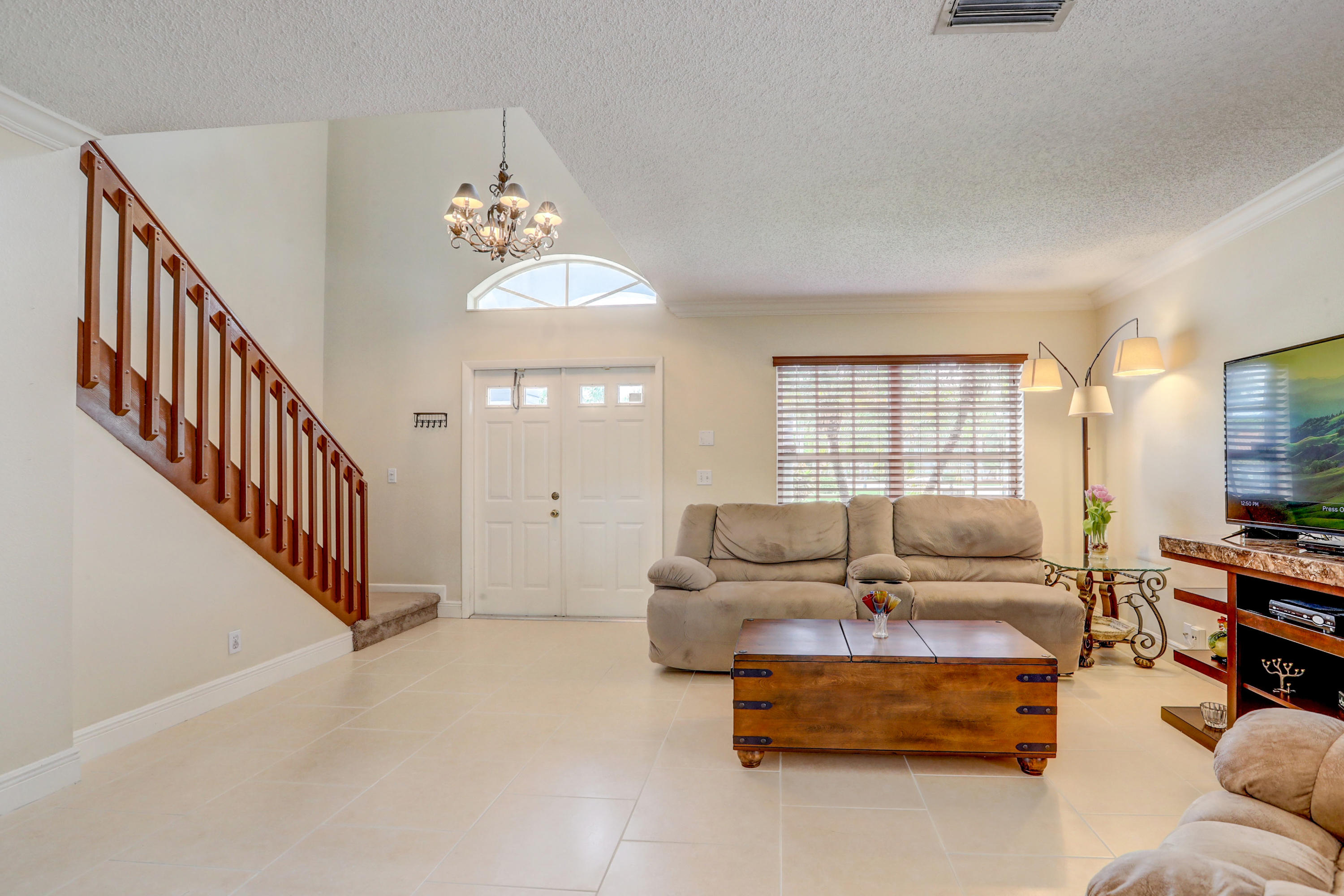 10620 Lake Jasmine Drive Boca Raton, FL 33498 - Photo 6 of 41 a living room with furniture and a chandelier