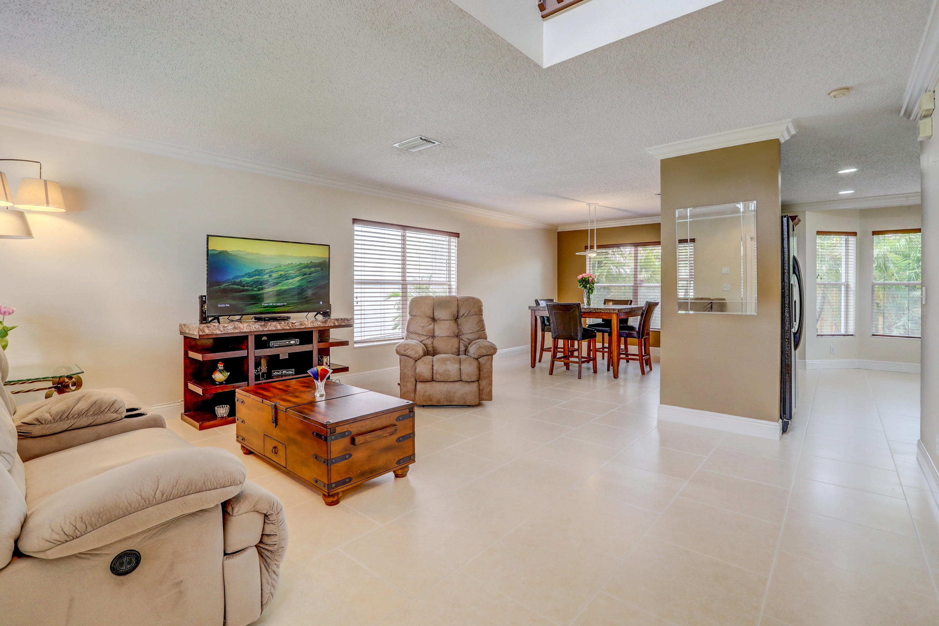 10620 Lake Jasmine Drive Boca Raton, FL 33498 - Photo 7 of 41 a living room with furniture and a flat screen tv