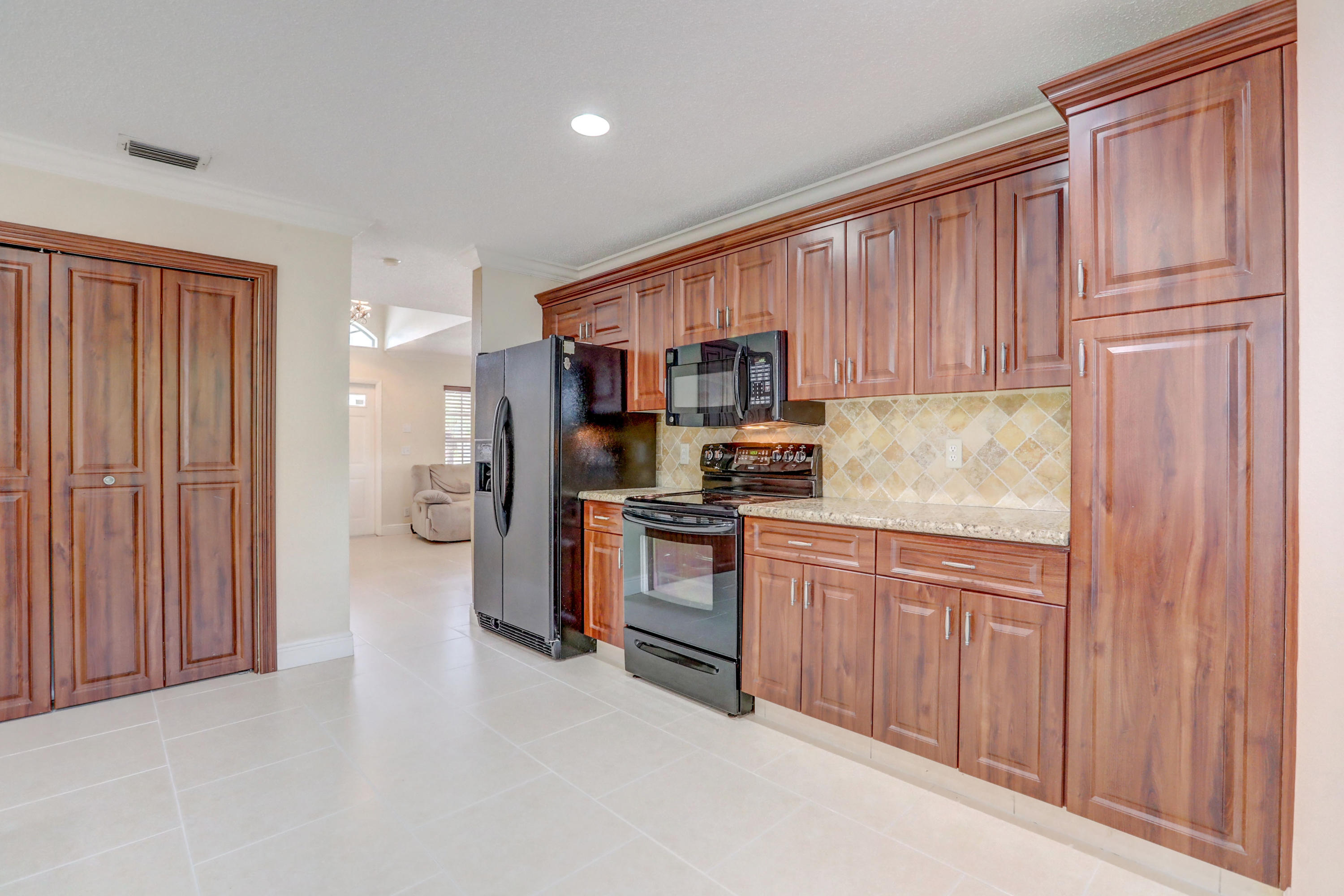 10620 Lake Jasmine Drive Boca Raton, FL 33498 - Photo 9 of 41 a kitchen with stainless steel appliances granite countertop a refrigerator stove and sink