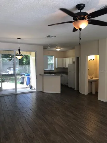 a view of a kitchen with a sink and wooden floor