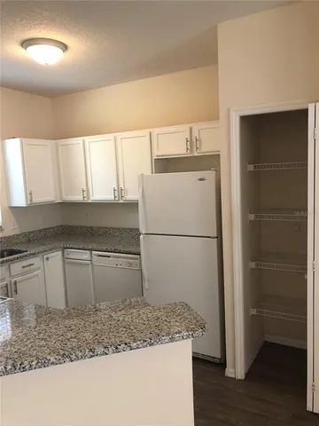 a kitchen with a refrigerator and a sink
