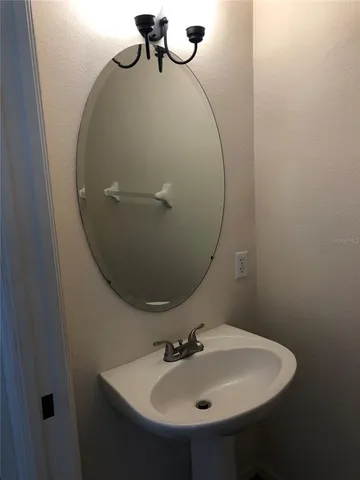 a bathroom with a sink and mirror
