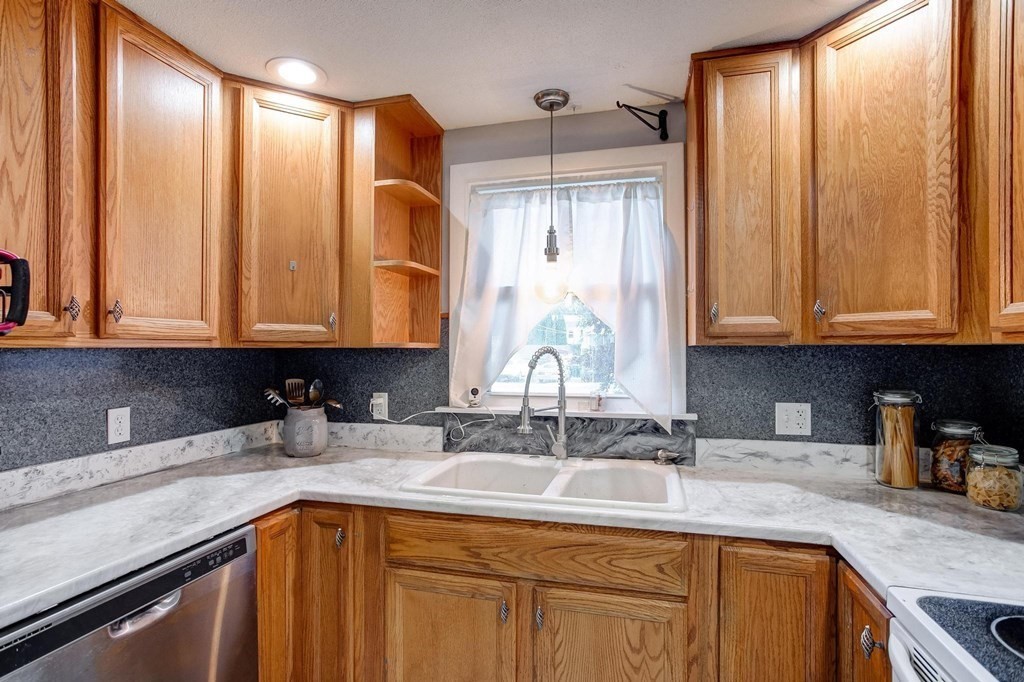 29 Basse Circle Lynn, MA 01905 - Photo 19 of 32 a kitchen with stainless steel appliances granite countertop a sink window and cabinets