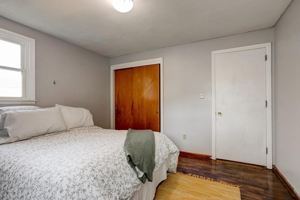 29 Basse Circle Lynn, MA 01905 - Photo 26 of 32 a bedroom with a bed and wooden floor