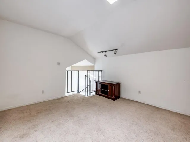 a view of empty room with a fireplace and window