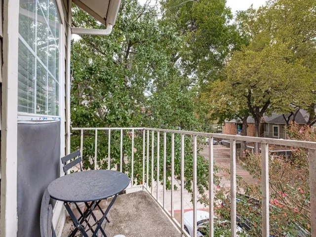 a view of a wooden deck and a backyard