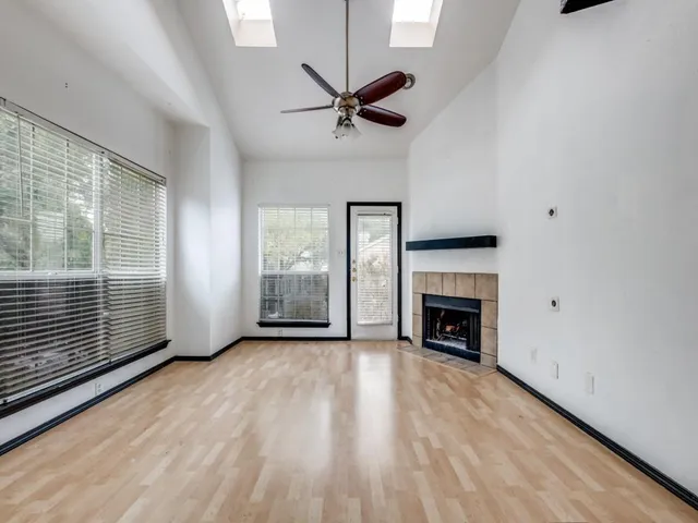 a view of a livingroom with a fireplace and window