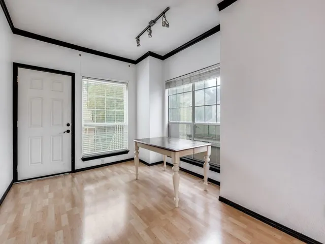 a view of an empty room with glass door