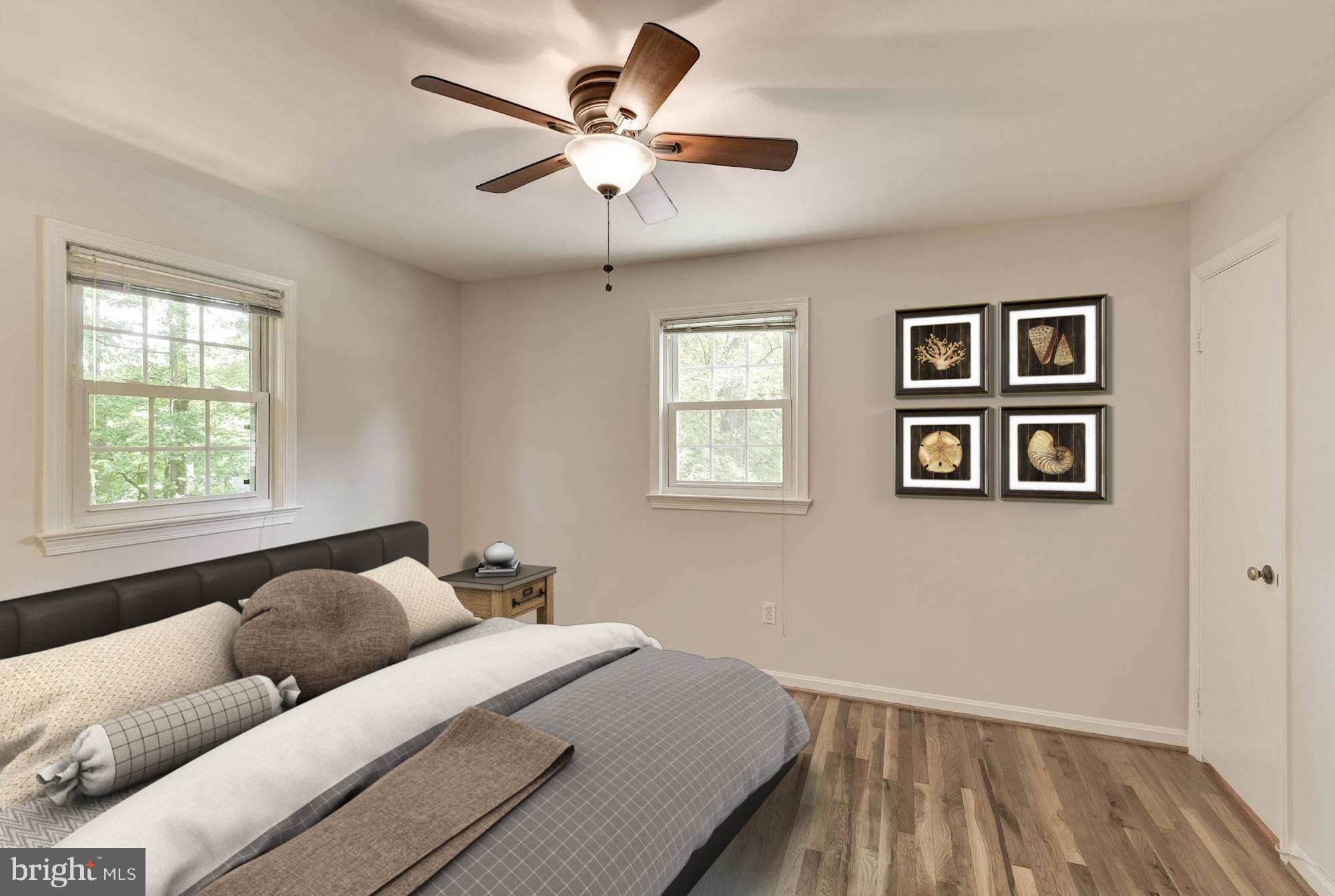 6732 Huntsman Boulevard Springfield, VA 22152 - Photo 11 of 23 a bedroom with a large bed and a window