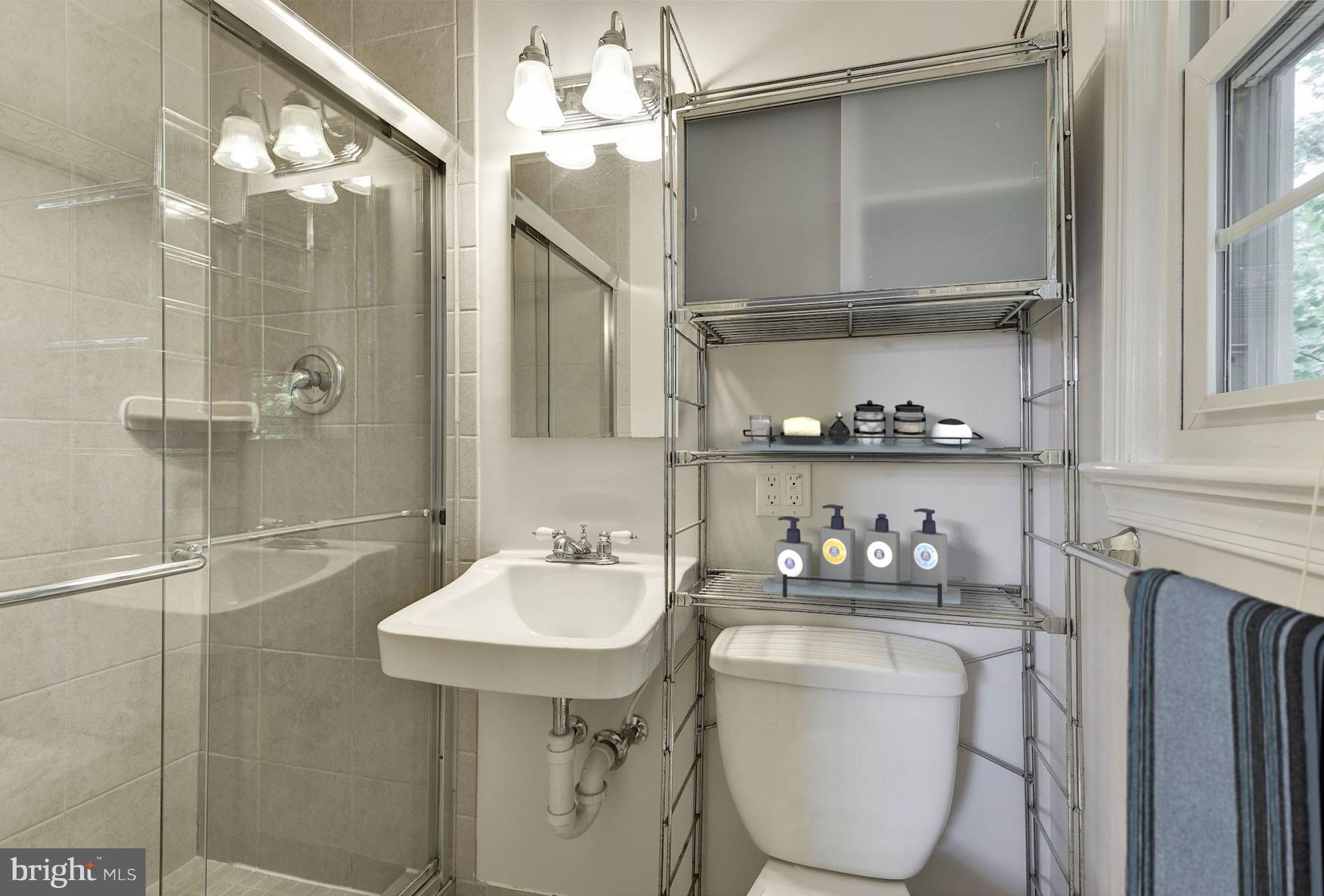 6732 Huntsman Boulevard Springfield, VA 22152 - Photo 12 of 23 a bathroom with a sink a toilet and shower