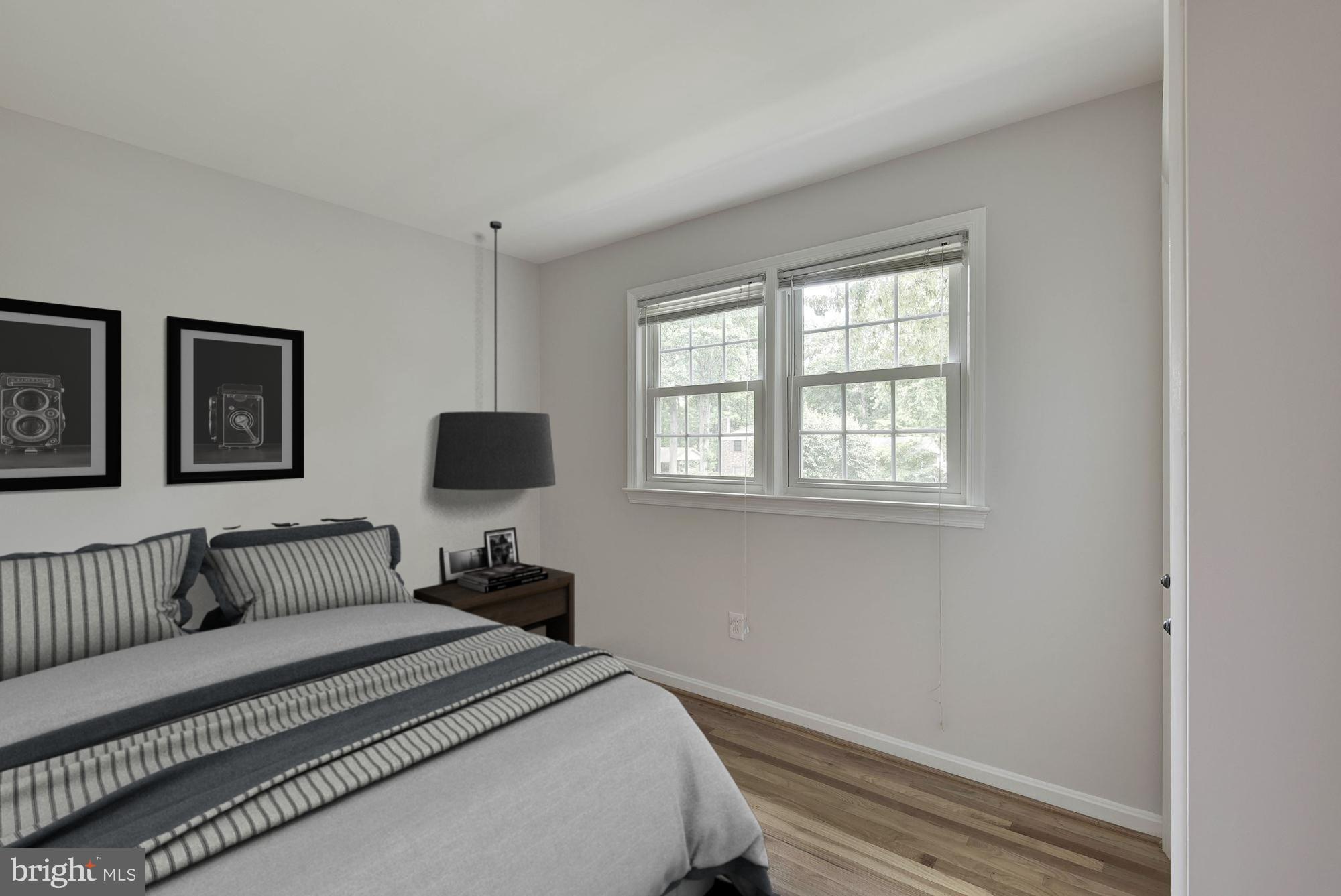 6732 Huntsman Boulevard Springfield, VA 22152 - Photo 14 of 23 a bedroom with a bed and a window