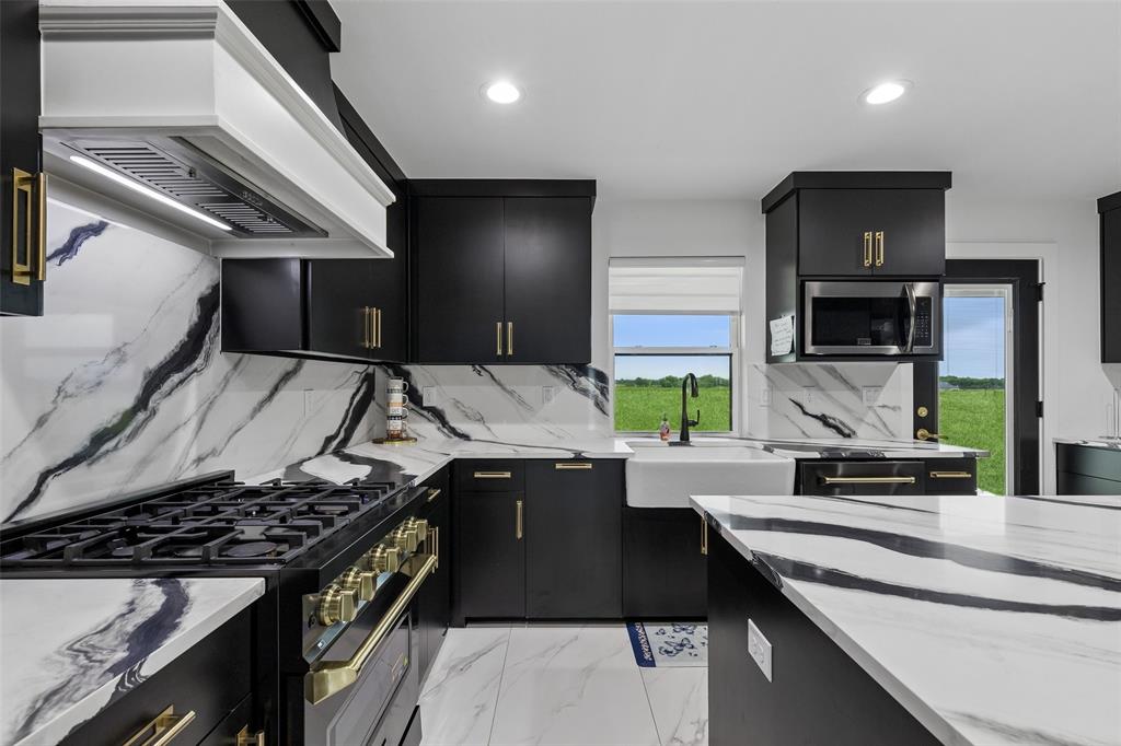1053 Sedalia Road Van Alstyne, TX 75495 - Photo 11 of 40 a kitchen that has a sink and a stove