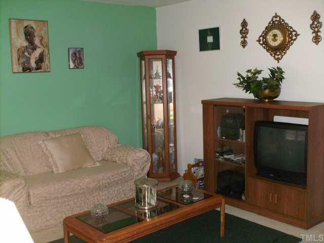 923 Edison Road Raleigh, NC 27610 - Photo 4 of 12 a living room with furniture and a fireplace