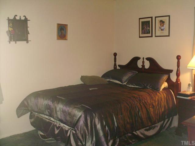923 Edison Road Raleigh, NC 27610 - Photo 8 of 12 a bedroom with a bed and a table