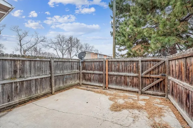 a view of wooden fence with large trees