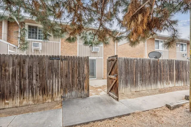 a view of outdoor space with wooden fence and a large tree