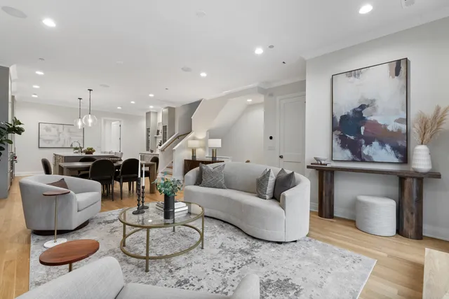 a view of a a dining room with furniture window and wooden floor