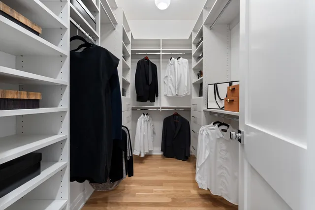 a bathroom with a toilet sink vanity and mirror