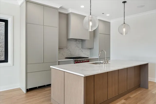 a kitchen with stainless steel appliances granite countertop a sink a stove and a refrigerator