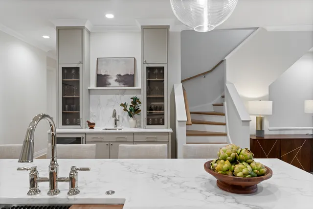 a kitchen with stainless steel appliances a sink stove and wooden floor