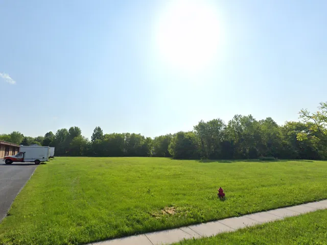 a view of a green field with clear sky