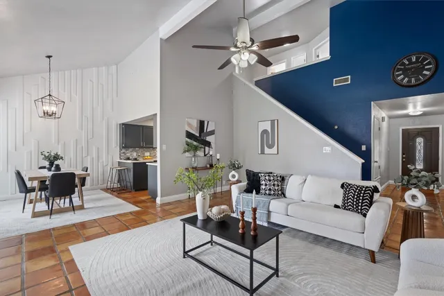a living room with furniture and a wooden floor