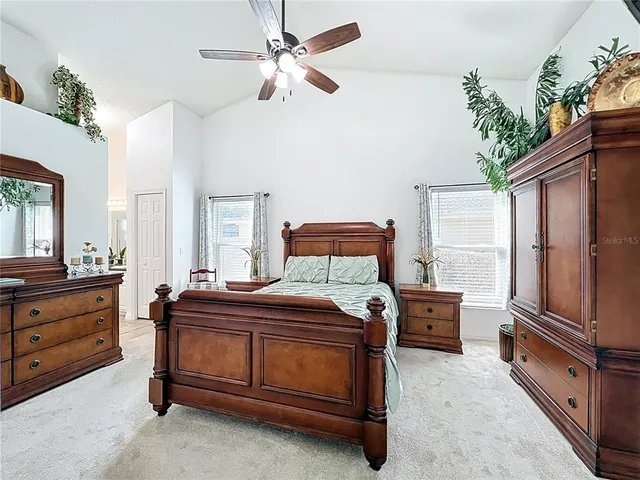 a dining room with furniture wooden floor a rug and a chandelier
